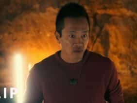 Explorer Albert Lin explores a cave burial site filled with ancient carvings